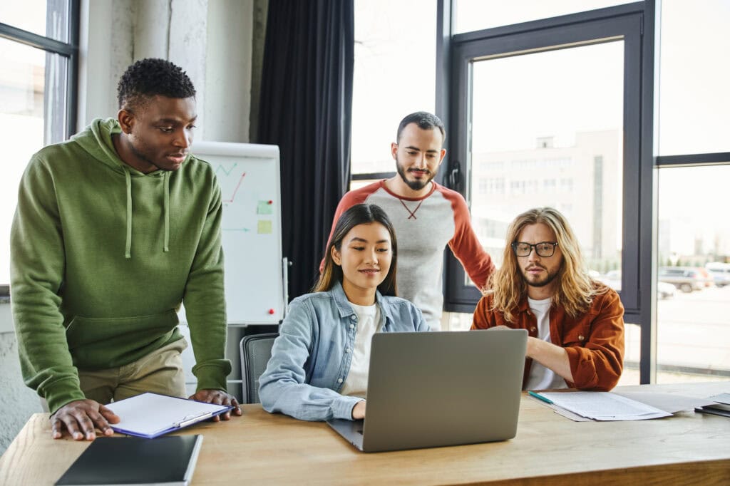 Diverse team collaborating on project in modern office