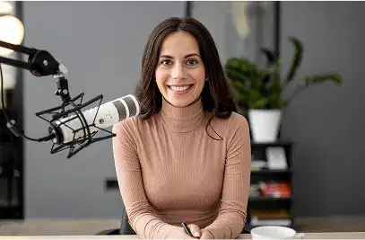 Woman smiling near a microphone in studio
